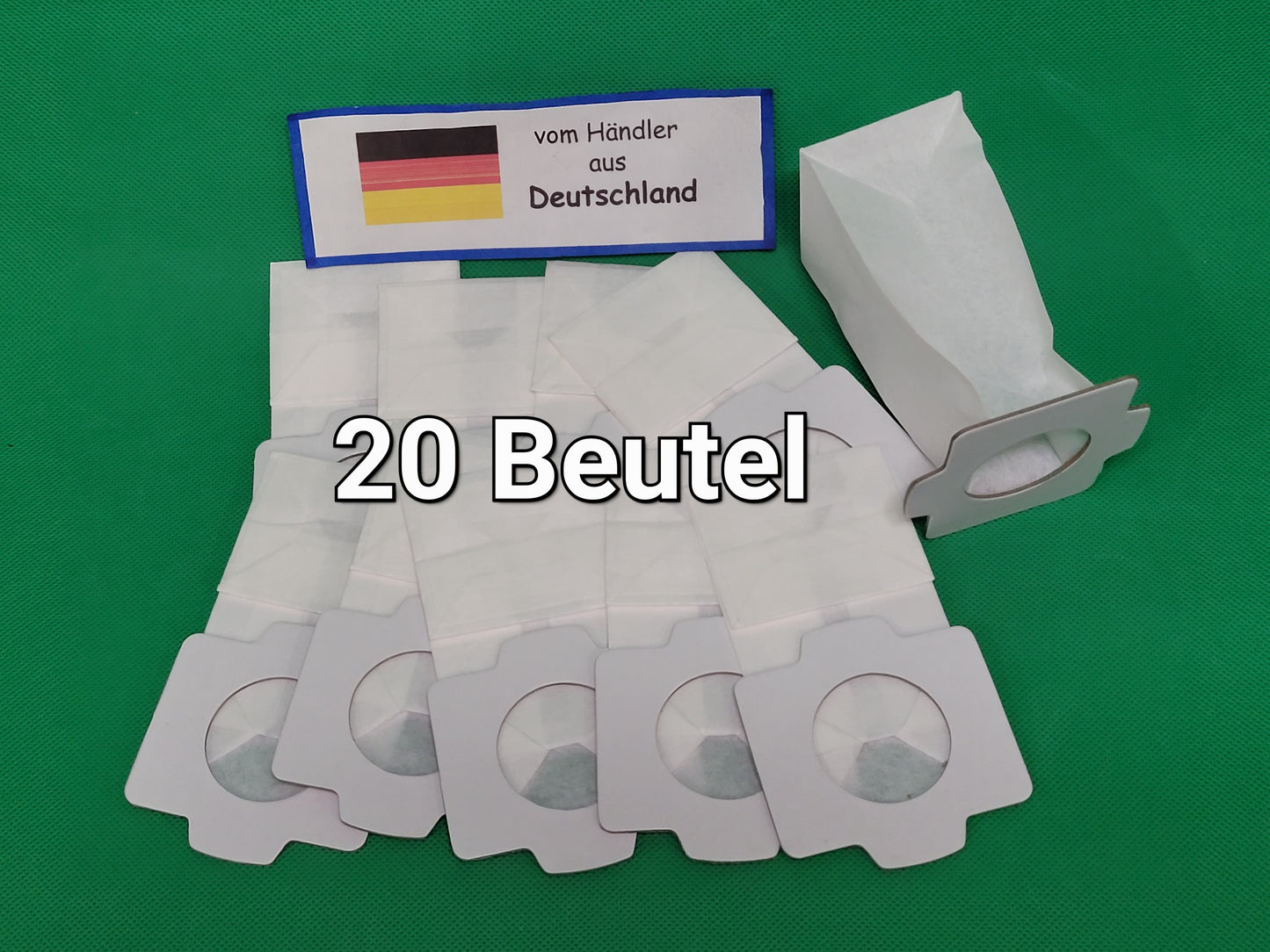 20 weiße immer-saugende Beutel, kompatibel mit Makita 194566-1 &amp; 198745-3, liegen mit Kartonmanschetten auf grünem Untergrund. Ein Schild mit deutscher Flagge und "vom Händler aus Deutschland" ist darüber zu sehen.